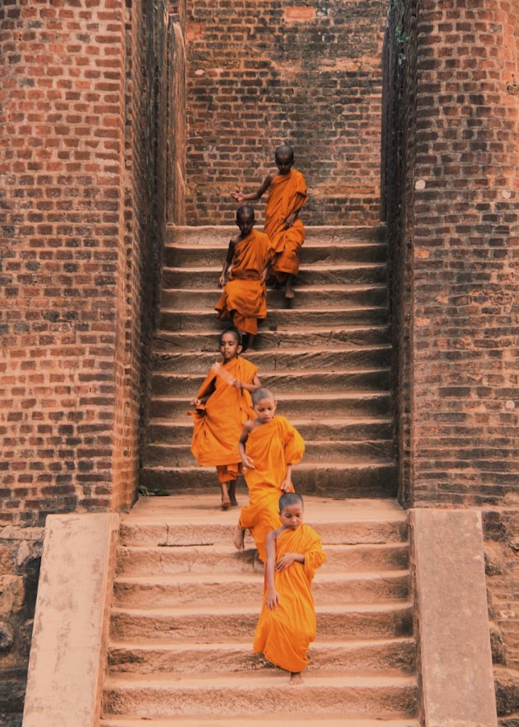 man in yellow jacket walking on gray concrete stairs
